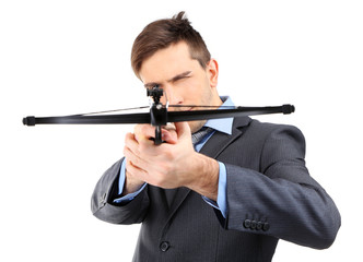 Young businessman with crossbow, isolated on white
