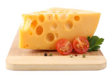 Piece of cheese and tomatoes, on wooden board, isolated on
