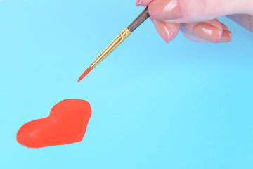 Heart drawn in pencil on a paper sheet close-up