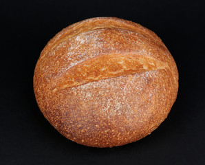 Loaf of bread on black background