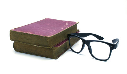 Old book and glasses on a white background