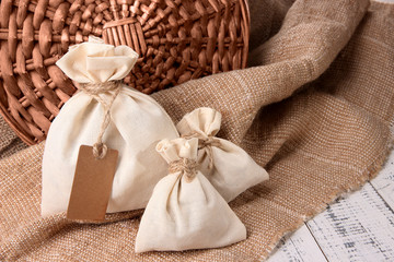 Jute bags on sackcloth, on wooden background