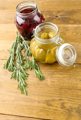 Tasty olives on wooden table, on natural background