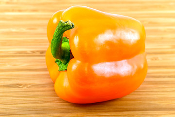 Orange Bell Pepper on wood