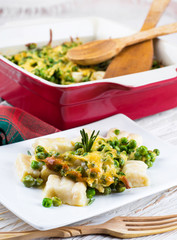 Cheese gnocchi with peas and rosemary