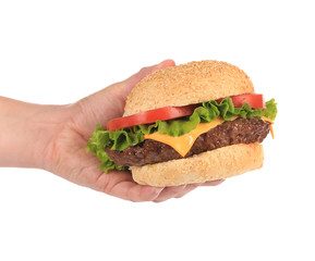 Big appetizing hamburger in hand.