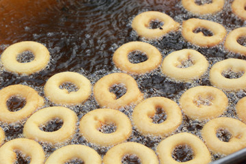 making donut fried in a pan
