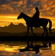 Obraz na płótnie Canvas Sylwetka kowboj z konia w zachodzie słońca