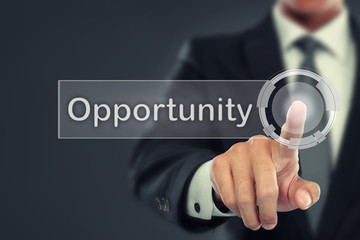 Businessman push to  Opportunity button on virtual screen