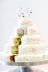 Delicious wedding cake in white , creme and pink