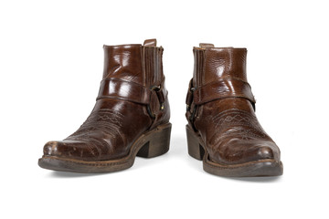 Old and worn cowboy boots isolated with clipping path.