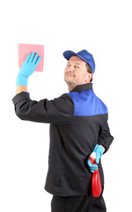 Man holds spray bottle and sponge.