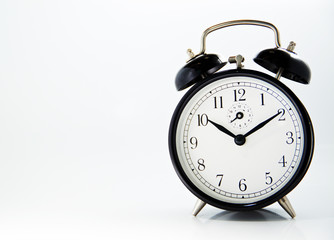 black old style alarm clock isolated on white
