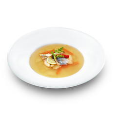 Hot tasty healthy soup with fish and vegetables served on a whit