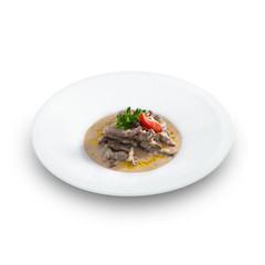 Delicious hot beef stroganoff with cream sauce served on a white