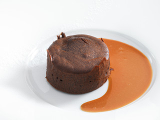 Delicious chocolate fondant with caramel sauce served on a white