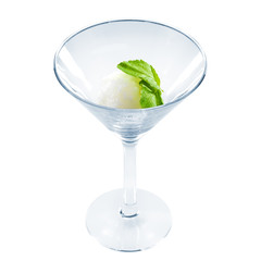 White sorbet with mint leaf in beautiful martini glass isolated