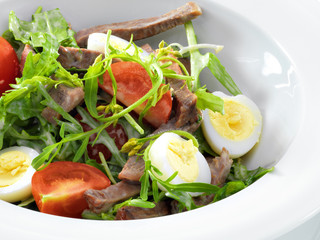 Warm delicious italian salad with beef tongue and arugula on a w