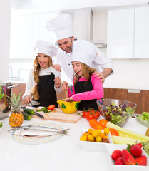 Chef master and junior pupil kid girls at cooking school