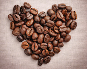 Heart from coffee beans on a linen cloth