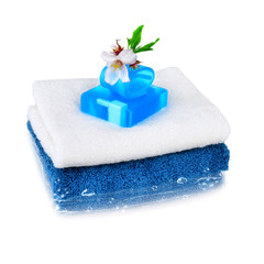 Obraz na płótnie Canvas White and blue towels with blue soap