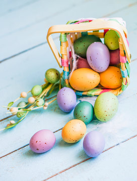 Easter eggs in the basket on blue wooden background