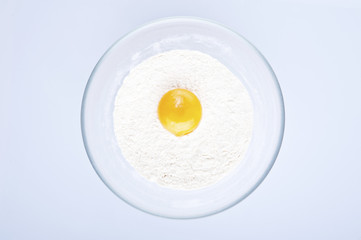 Eggs, flour and butter isolated on white