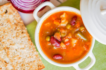 Minestrone soup on wooden background