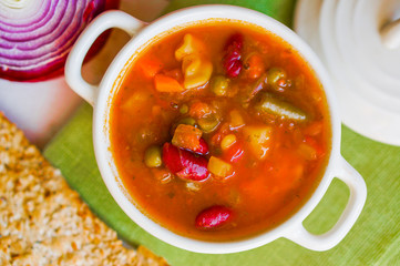 Minestrone soup on wooden background