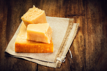 Parmesan Cheese on Wooden Background close up. Piece of Parmesan