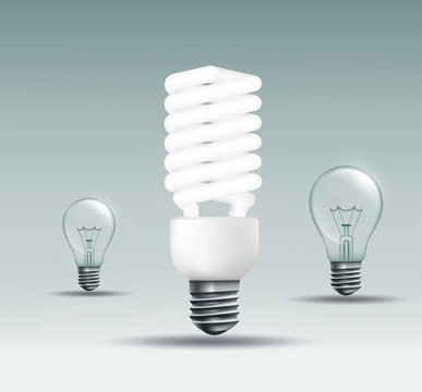 energy saving lamp and incandescent lamp on a dark background