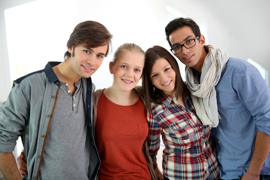 Group of cheerful students standing in school campus