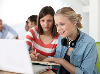 Students girls studying together on laptop