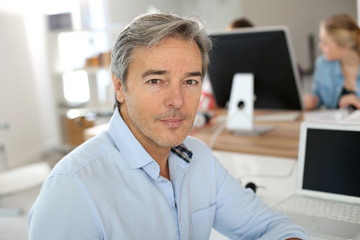 Portrait of mature teacher in classsroom