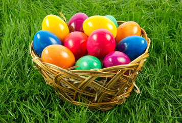 easter eggs in busket on green gras isolated