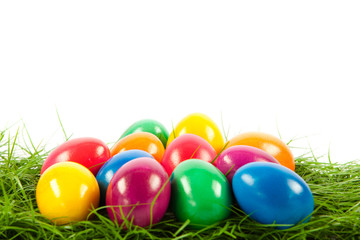Fototapeta na wymiar easter eggs in busket on green gras isolated