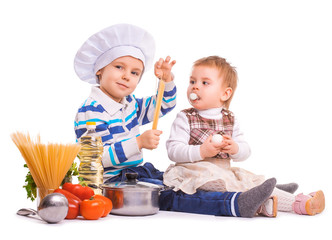 funny kids are cooking on the kitchen. isolated