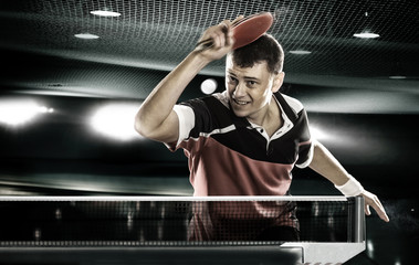 sports man tennis-player on black background