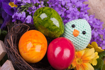 one green chick and eggs and flower