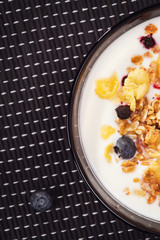 Muesli with yogurt and fresh blueberries. Background