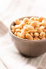 peanuts in a bowl on tablecloth