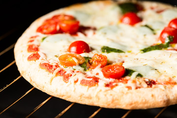 Cooking pizza in oven close up