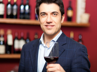 Handsome man holding a glass of wine