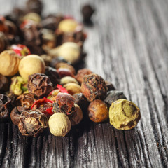 pepper corns on a wooden board
