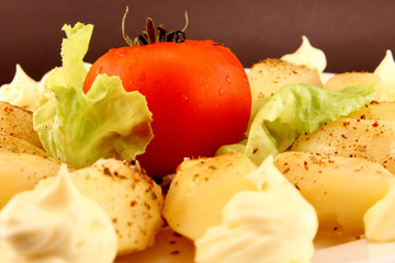 Baby potatoes and tomato closeup