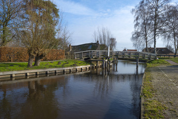 Fototapeta na wymiar Wooden bridge over a canal in winter