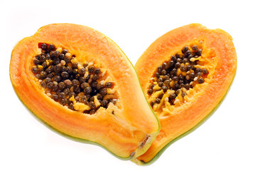 two halves of fresh papaya isolated on white