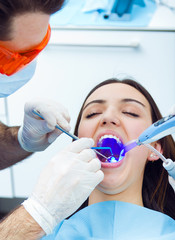 Cute young woman at the dentist. Mouth checkup