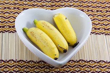 Fresh bananas on a heart shaped bowl