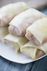 Fototapeta na wymiar Unprepared cabbage rolls with ground meat and rice, close-up